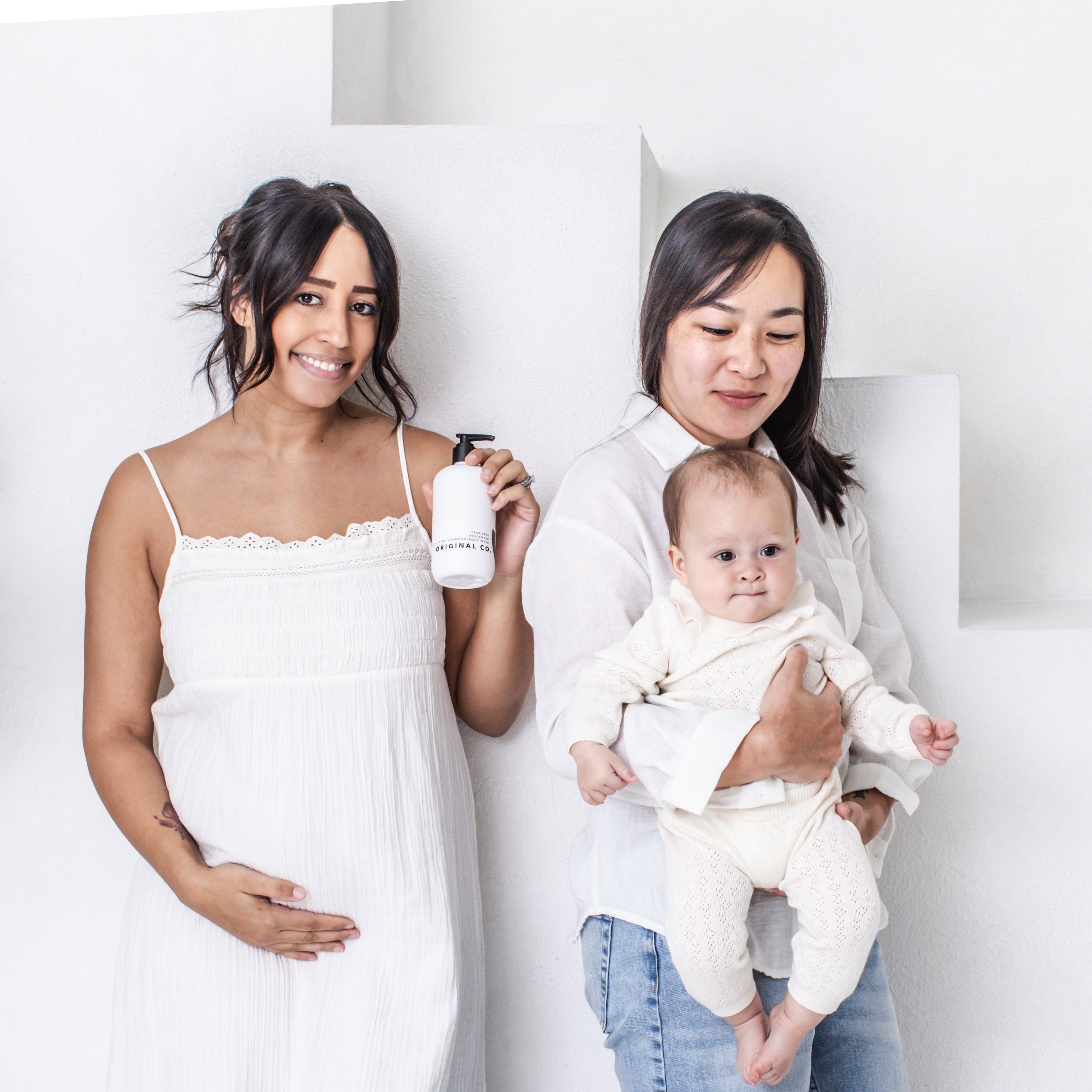 two mothers one holding a baby one pregnant both using the everday body wash by original co.